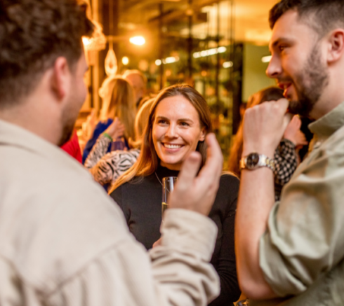 Three people chatting at a networking event.